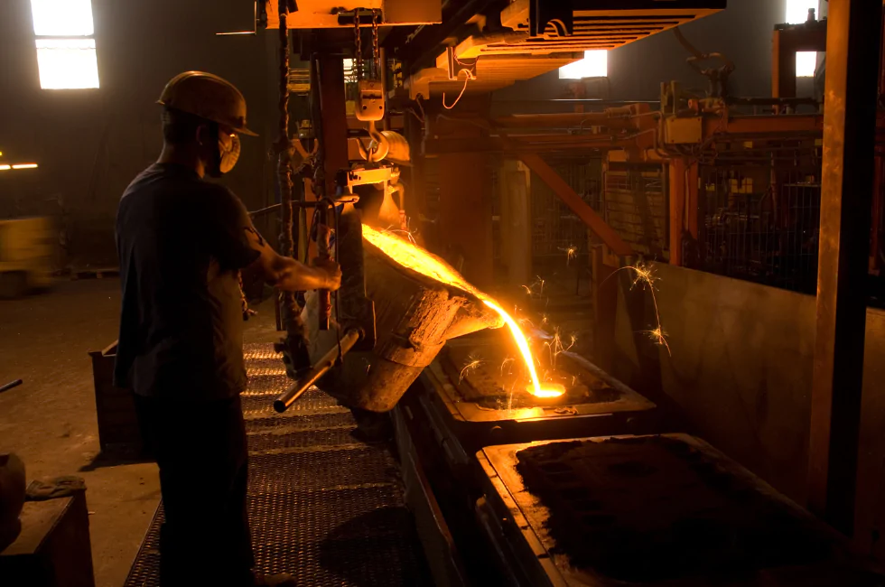 local steel supplier pouring melted metal into mould